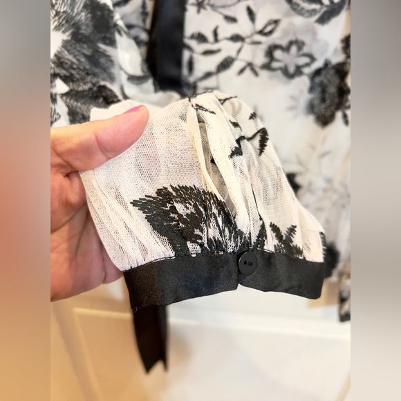 White sheer black floral top with black satin bow ribbon at neck w/ feathers. - Picture 4 of 5